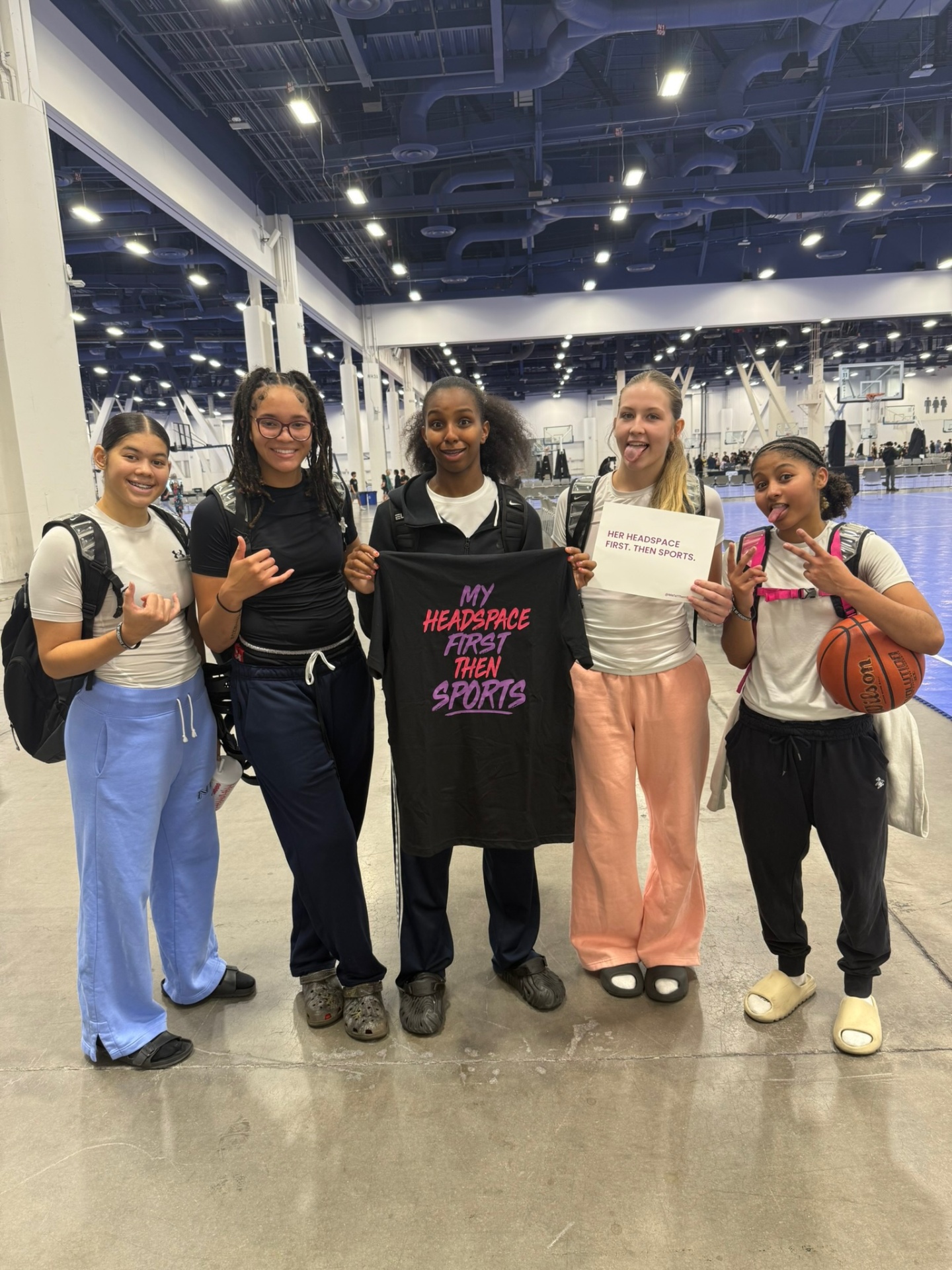 Teen girl athletes from multiple sports together before a Me 1st Then Sports™ experience